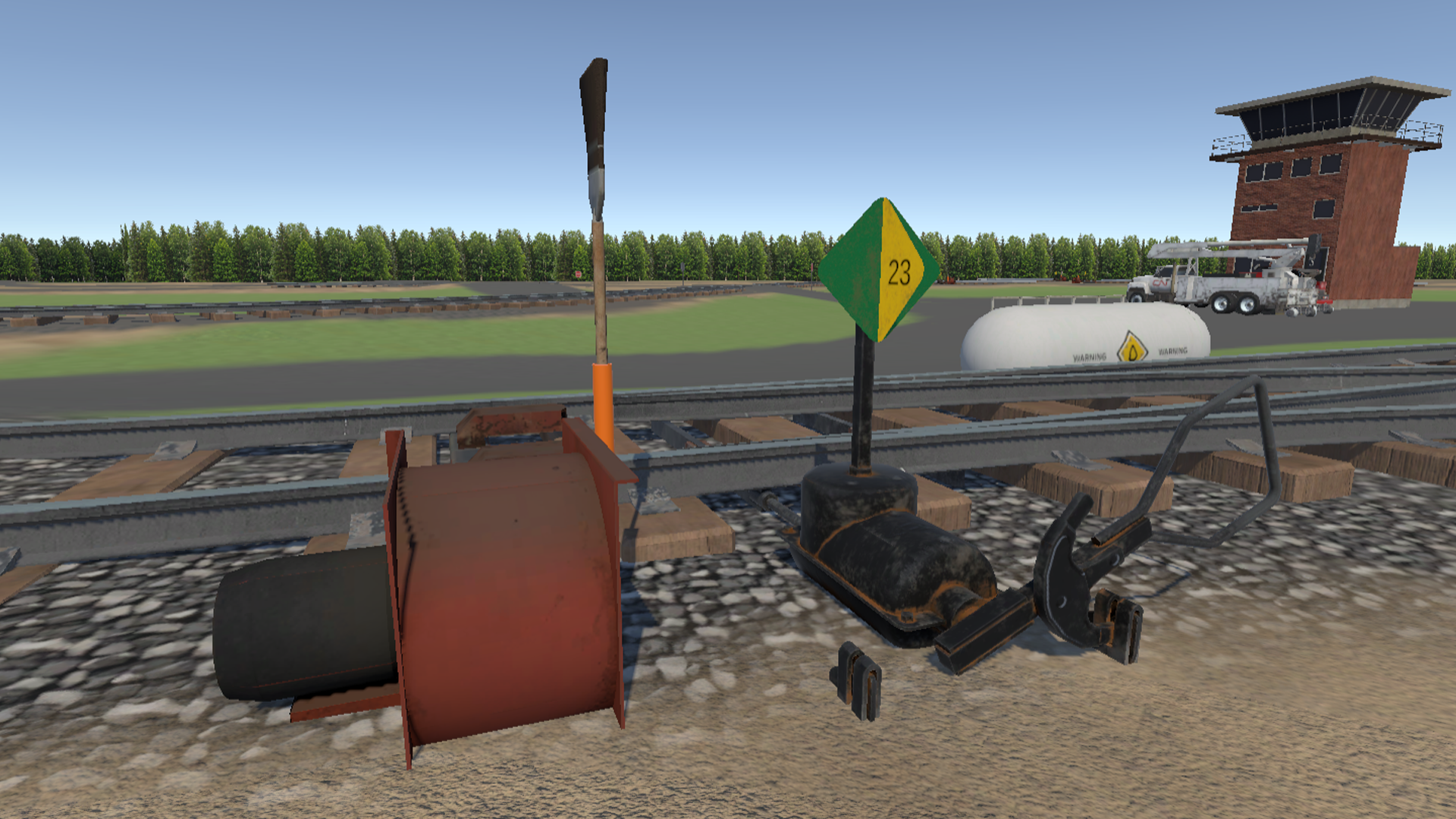 MacMillan yard close-up of switch stand derail and green indicator diamond with control tower in background