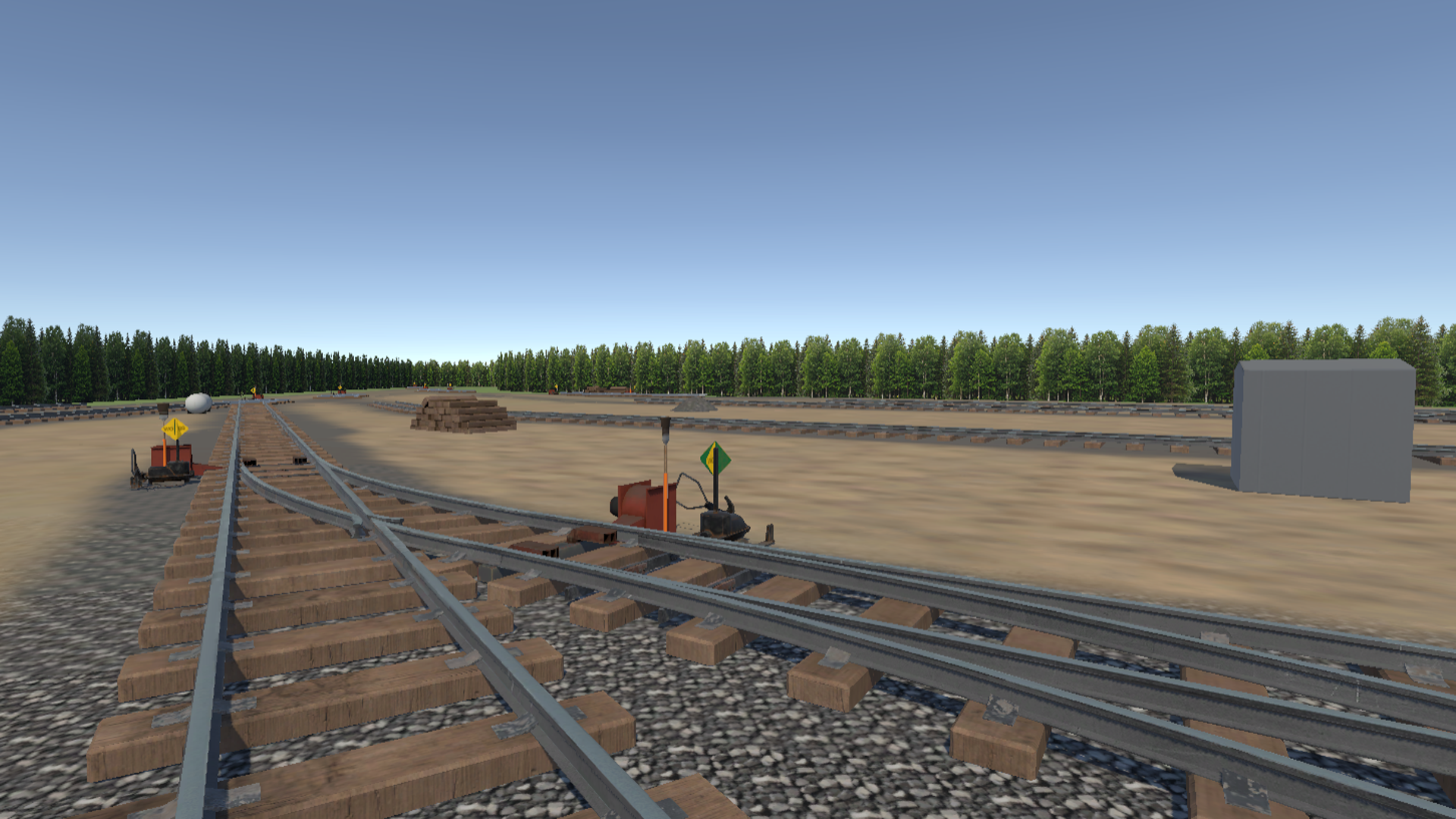 FIT yard ground level view with switch stand, derail, and broom beside warning tank